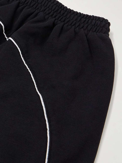 BALENCIAGA - WIDE-LEG DISTRESSED LOGO-APPLIQUÉD COTTON-JERSEY SWEATPANTS